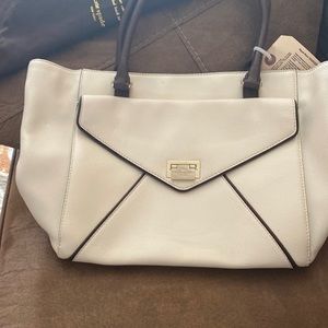 Kate spade purse Tan with brown trim slightly used comes with a duster